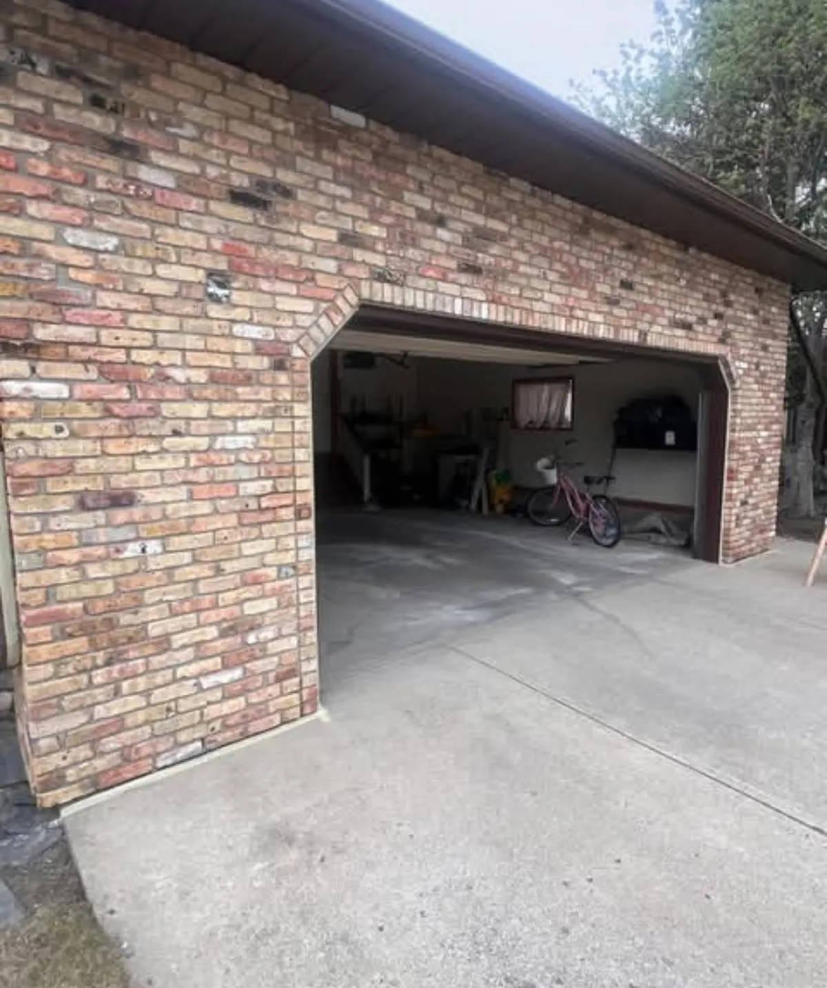 Detached garage in mixed red and buff brick before painting