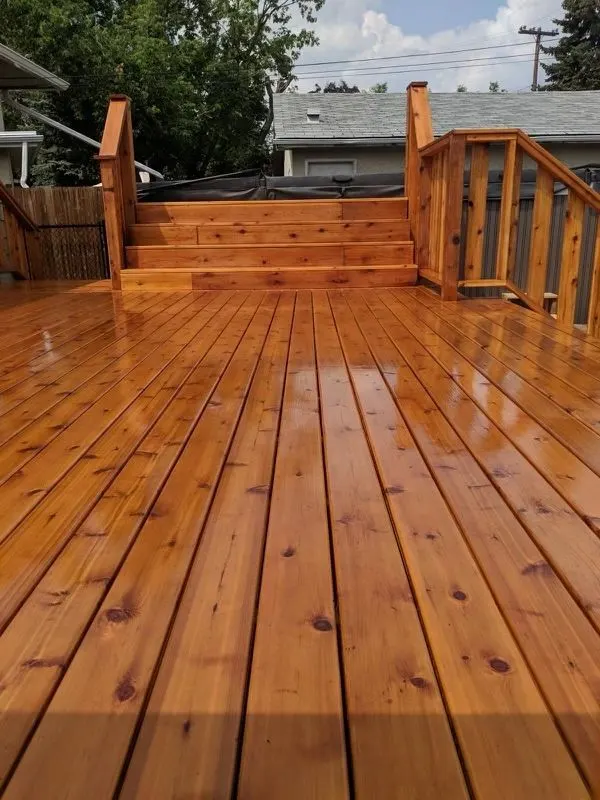 Wet-look cedar deck boards leading to a stair and railing