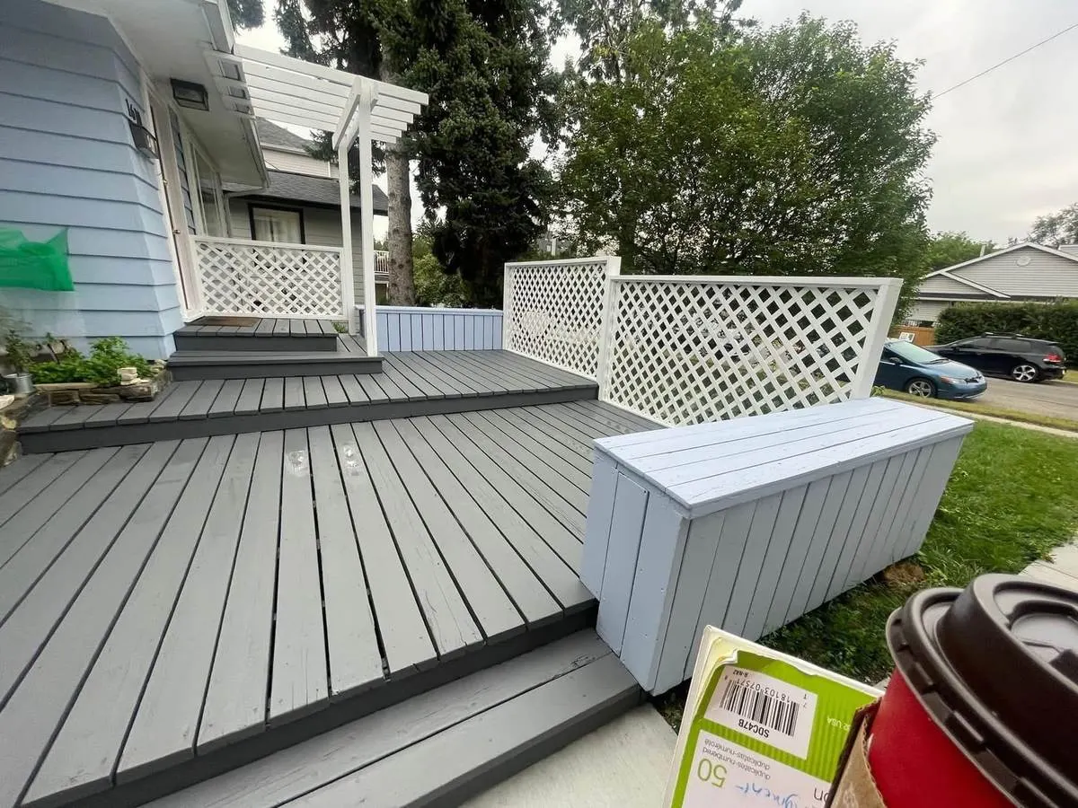 The same deck painted two-tone grey with a white lattice privacy screen