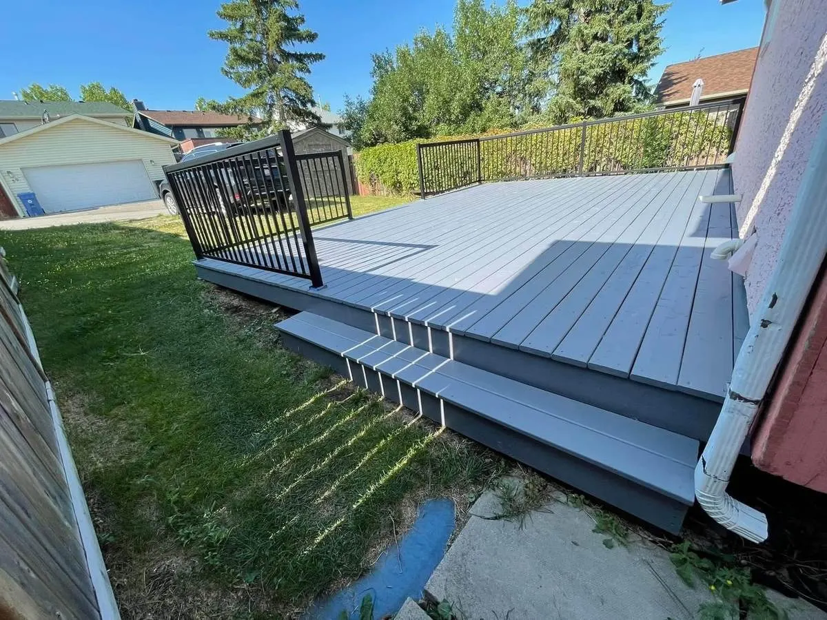 The same deck after refinishing with light grey boards and charcoal fascia